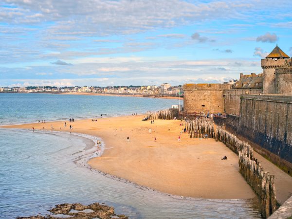 Atlantic beach under the towers of city walls in St Malo in English Channel, Brittany, France